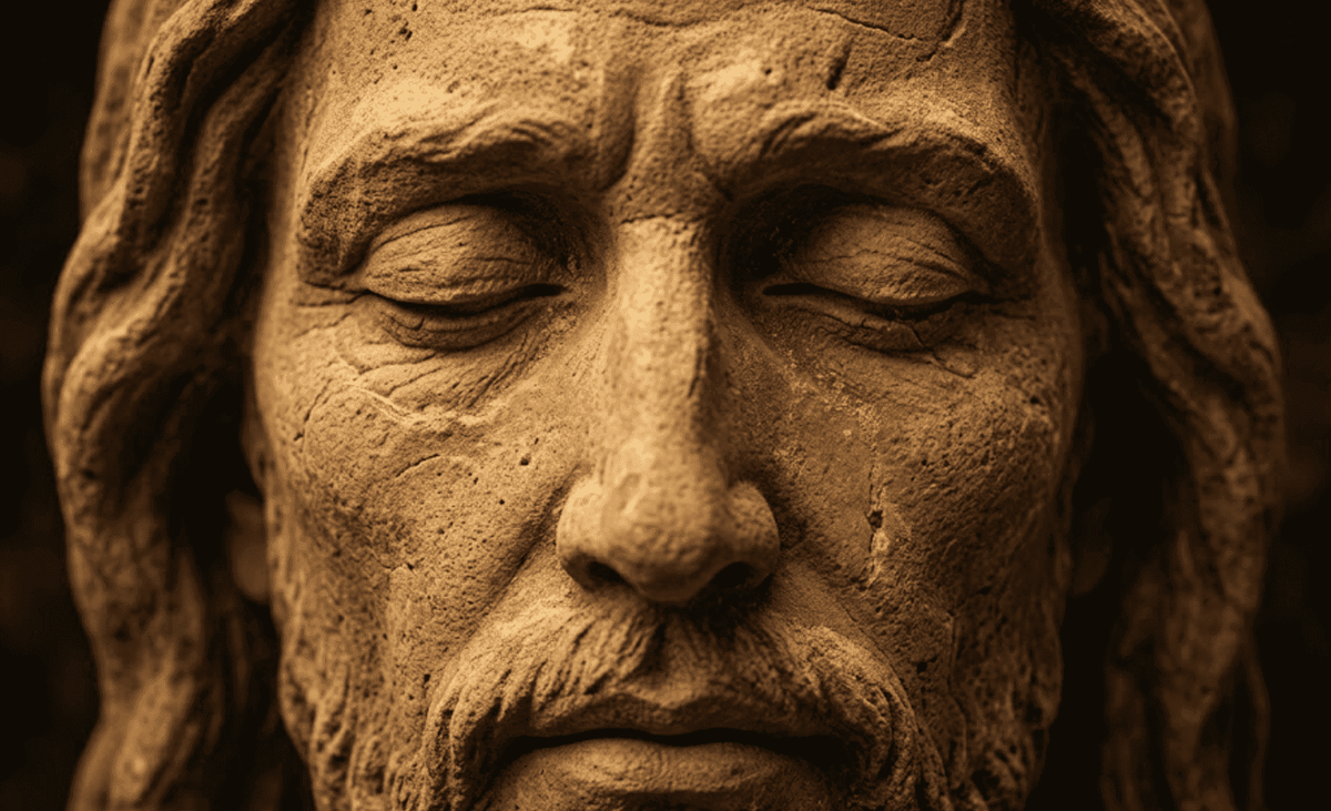 Rosto de Cristo em detalhe hiperrealista e cinematográfico, com olhos fechados em profunda paz e misericórdia. A imagem foca na textura de areia e pedra, simbolizando a Meditação Quaresma sobre o amor incondicional e o rosto de Deus que acolhe a nossa miséria.